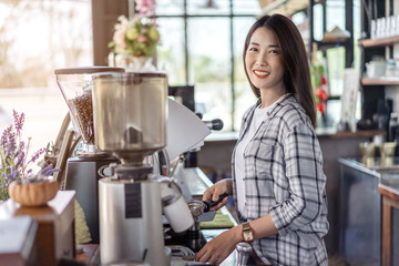 woman preparing coffee with machine in cafe