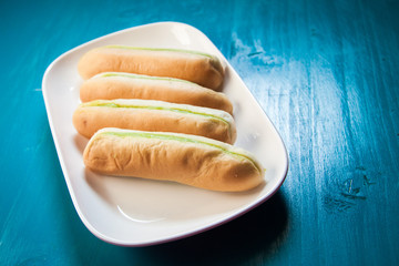 Bread with green steamed custard from on the plate and blue wood background  
