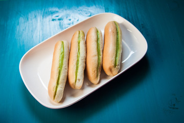 Bread with green steamed custard from on the plate and blue wood background  