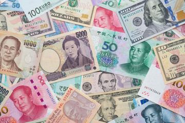 Flat lay or top view of world international banknotes vary countries background. US Dollar, Chinese...