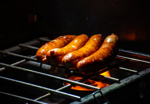Grilled Sausages on a propane grill at an outdoor camp site