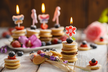Fruit, berry and pancake canapesFruit, berry and pancake canapes on white wooden table