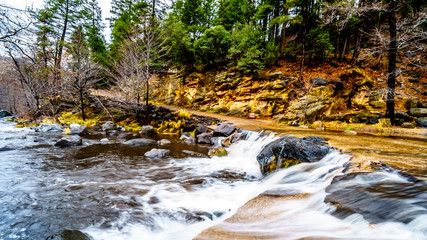 After heavy rainfall, water from Oak Creek flooding the road crossing Oak Creek at Orchard Canyon at Arizona SR89A between Sedona and Flagstaff in northern Arizona, United States of America