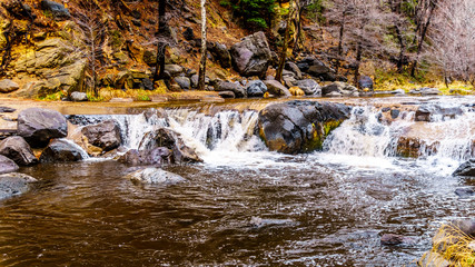 After heavy rainfall, water from Oak Creek flooding the road crossing Oak Creek at Orchard Canyon at Arizona SR89A between Sedona and Flagstaff in northern Arizona, United States of America