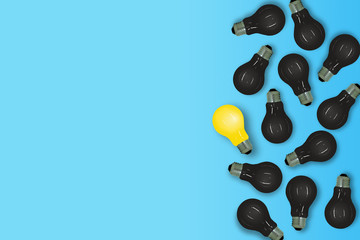 Business Creative and Idea Concept : Yellow light bulb lie on blue background surrounded with many black light bulb.