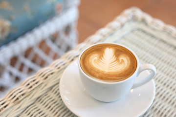 heart shape latte art of hot coffee drink tasty on white table in cafe