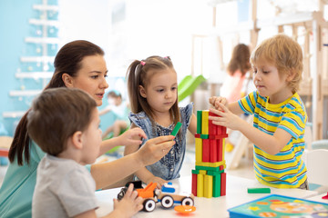 Little kids build block toys at home or daycare. Kids playing with color blocks. Educational toys...