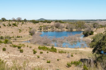 View of Large Rock Formation in the Distance With Lake in the Foreground