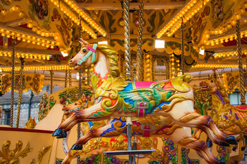 Colorful horse carousel at an amusement park.