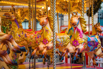 Fototapeta na wymiar Colorful horse carousel at an amusement park.