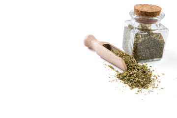 marjoram in wooden scoop and jar on isolated on white background. copy space added