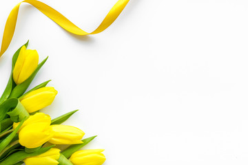 Spring composition. Delicate yellow tulips on white background top view space for text border