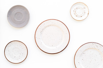 Ceramic plates pattern on white background top view