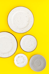 Mockup with plates. Empty ceramic plates on yellow background top view copy space