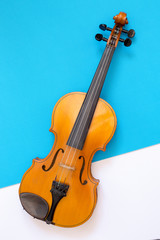 Fototapeta na wymiar Violin on a multi-colored background, top view