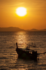 Fototapeta na wymiar boat at sunset in asia