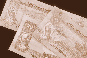 Fototapeta na wymiar UAE dirham currency background close up. Brown color toned
