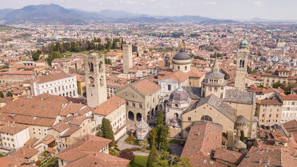 Fototapeta na wymiar Bergamo, Italy. Drone aerial view of the old town. Landscape at the city center, its historical buildings, churches and towers