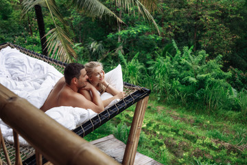 Honeymoon at Bali, Ubud. Successful couple relaxing at villa, beautiful view