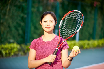 portrait of young female asian tennis player