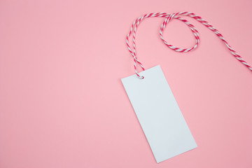 white empty label on a pastel pink background