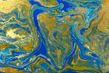 Blue and gold marbling pattern. Golden marble liquid texture.