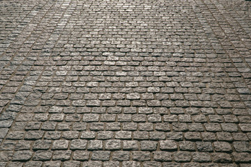 Old cobbled stone texture background, pavement structure on road.
