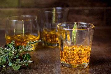 glasses of whiskey with ice cubes  on  bar.