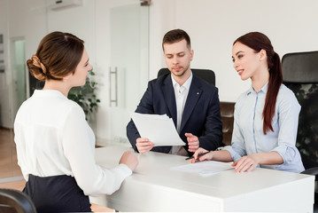Fototapeta premium Job interview. Successful young employees working together. Business concept of co-workers in the office space.