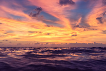 Tropical beach with sunset sky and cloud background.