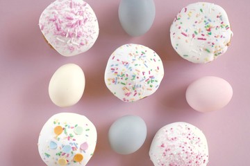 Easter food.Easter cake and eggs in pastel colors on a light pink background.