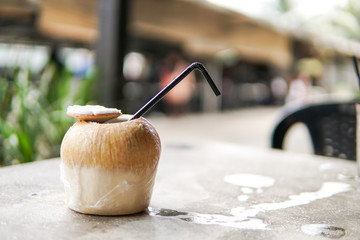 Close Up of Coconut water with blurred background and copyspace.