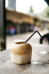 Close Up of Coconut water with blurred background and copyspace.