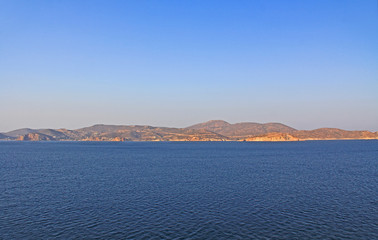 View of the island of Patmos, Greece in the Aegean Sea where St. Paul wrote the book of Revelation in the Bible with beautiful blue sky and water copy space.
