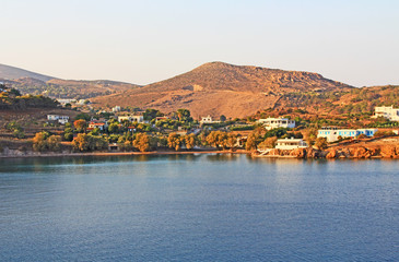 View of the island of Patmos, Greece in the Aegean Sea where St. Paul wrote the book of Revelation in the Bible with beautiful blue sky and water copy space.