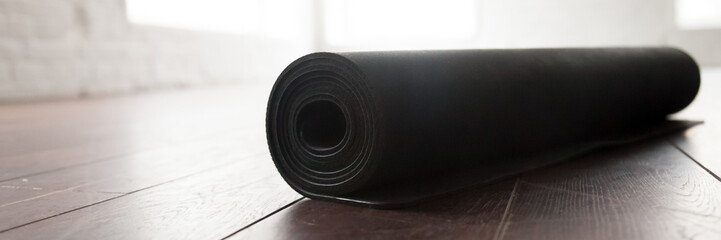 Horizontal image yoga fitness mat in a roll close up
