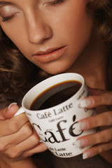 lifestyle, food and people concept: young pretty woman drinking coffee