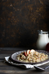 Buckwheat porridge with milk, apple, raisins and cashew nuts