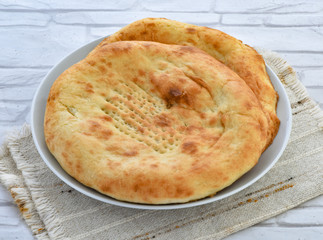 a traditional pakistani fluffy and oily bread baked in clay oven