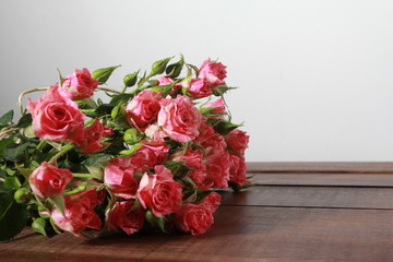 Bunch of roses on dark wooden table. Women day concept. Holiday, 8 march, birthday, anniversary, spring