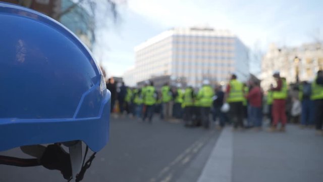 A blurred view of construction workers on a strike.