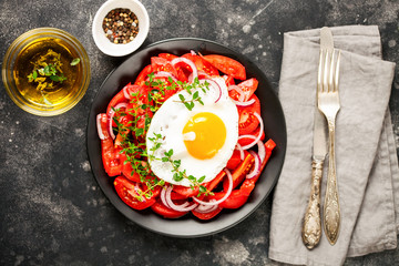 Tomatoes and fried eggs