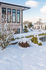 A typical american house in winter. Snow covered.