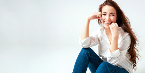 Beauty fashion portrait of smiling sensual asian young woman with dark long hair in white shirt on...