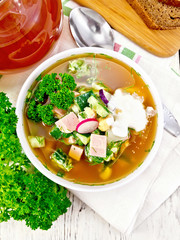 Okroshka in white bowl on light board top