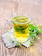 Tea of thyme in mug on board