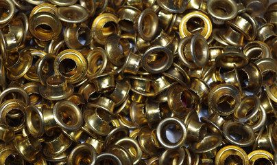 Eyelets (small grommets) for reinforcing punched holes in thick paper or cardboard