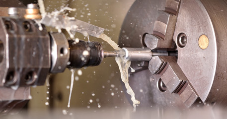 Spindle chuck and installed metal part in pocessing on high precision Cnc industrial lathe turning...