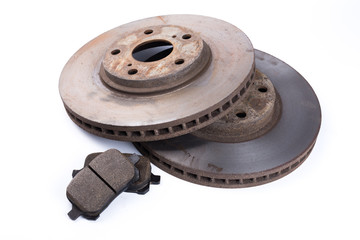 Brake pads and brake discs on white background