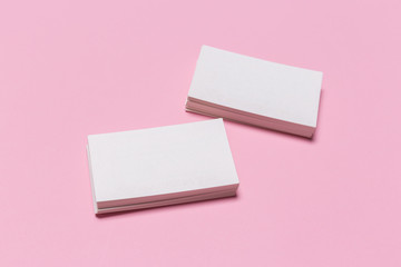 Obraz na płótnie Canvas Blank white business cards on pink background.